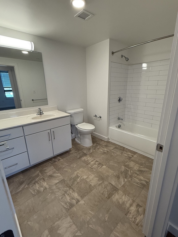 466 River Street, Unit 308 Boston, MA 02126 - Photo 5 of 17 a bathroom with a granite countertop sink a toilet and shower