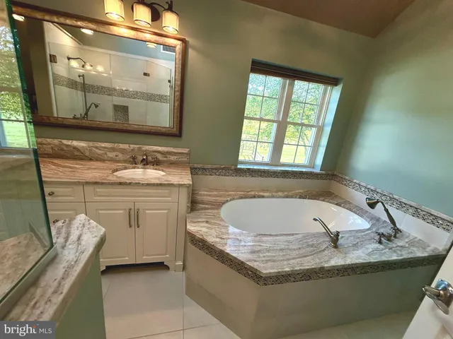 a bath tub sitting in a bathroom next to a window