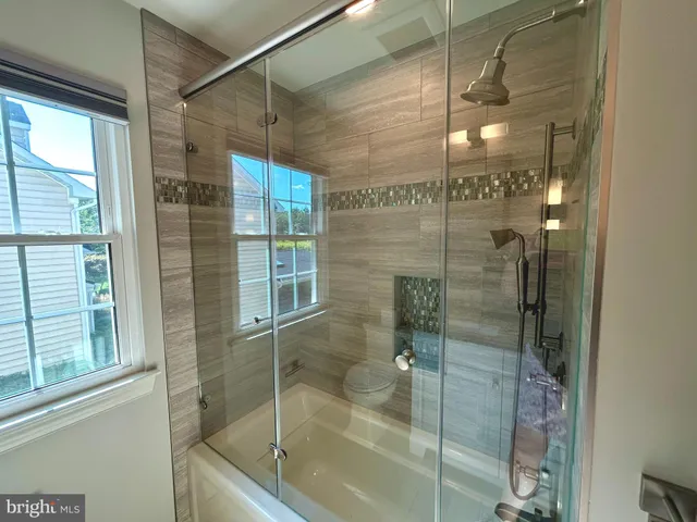 a bathroom with a glass shower door