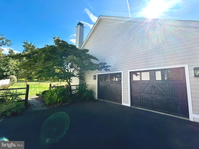 a backyard of a house with lots of green space and garden