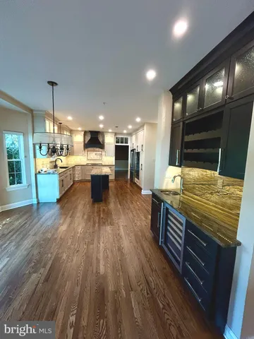 a kitchen view with a stove and wooden floor