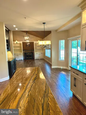a spacious bathroom with a sink and a wooden floor