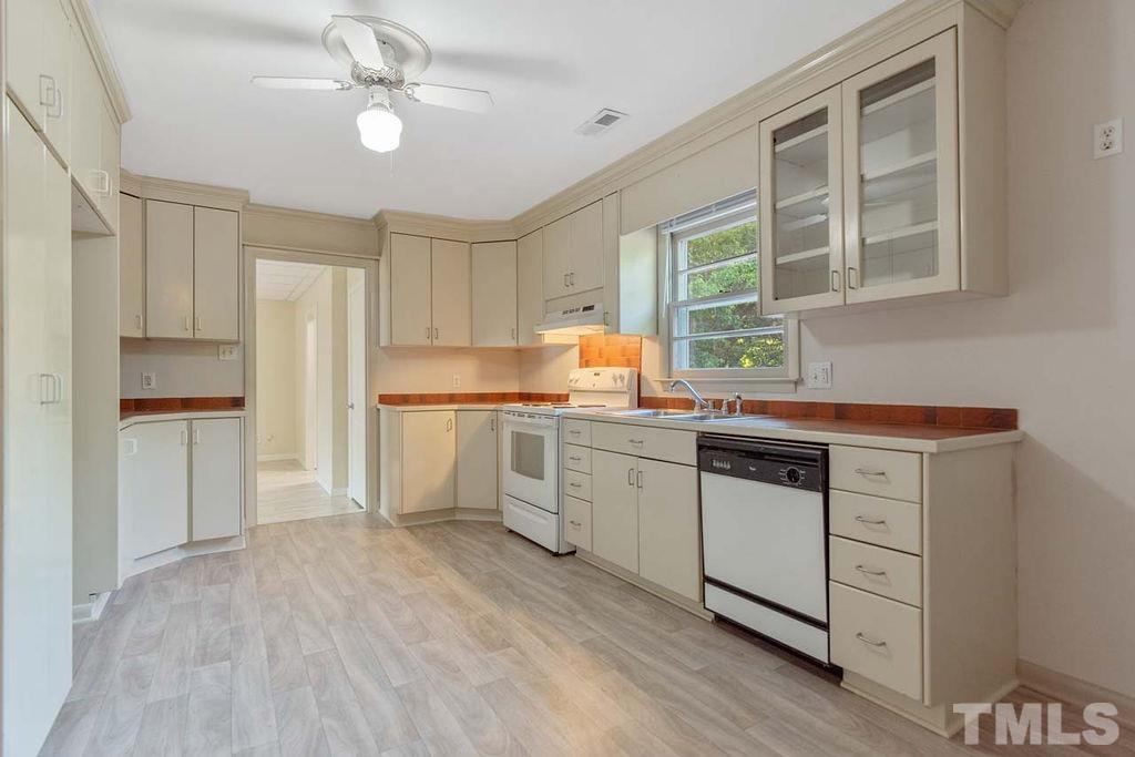 3806 Lee Road Raleigh, NC 27604 - Photo 11 of 33 a kitchen with a refrigerator a sink and dishwasher with wooden floor