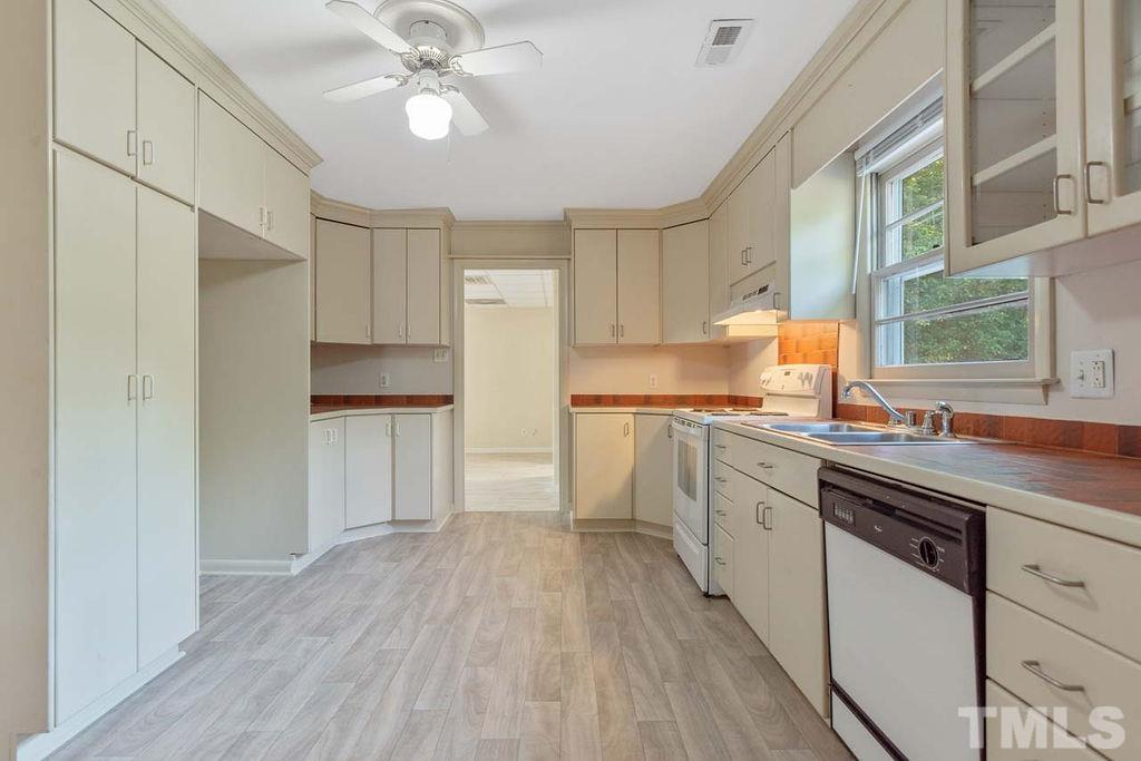 3806 Lee Road Raleigh, NC 27604 - Photo 12 of 33 a kitchen with cabinets a sink and appliances