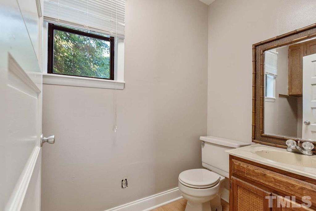 3806 Lee Road Raleigh, NC 27604 - Photo 29 of 33 a bathroom with a granite countertop toilet and a sink