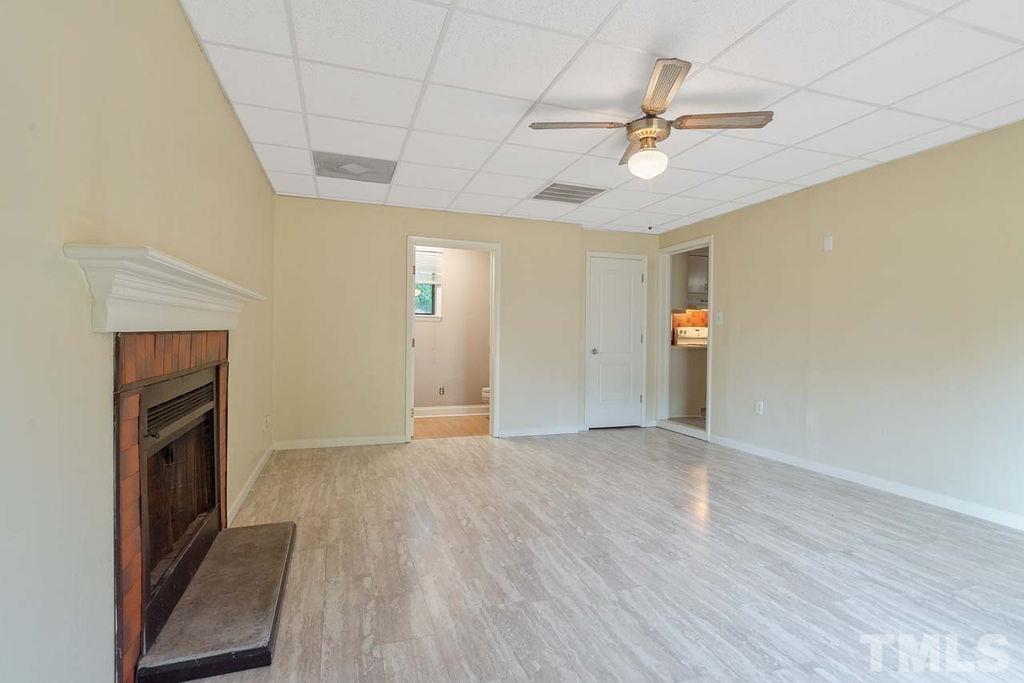 3806 Lee Road Raleigh, NC 27604 - Photo 7 of 33 wooden floor in an empty room with a fireplace