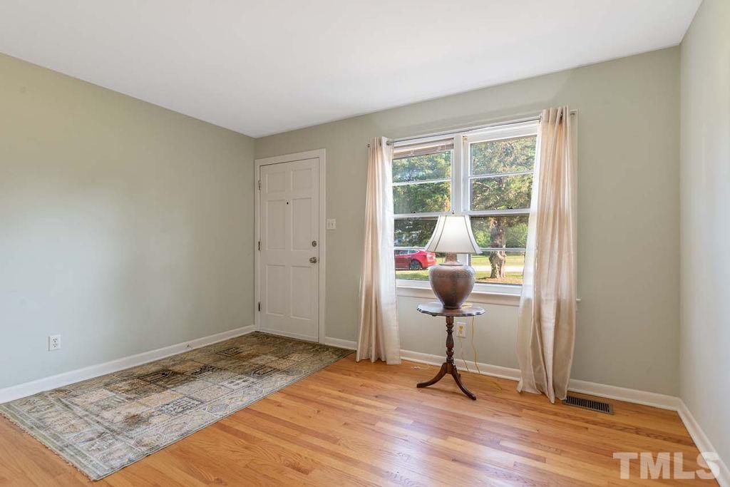 3806 Lee Road Raleigh, NC 27604 - Photo 9 of 33 a view of a livingroom with wooden floor and a rug