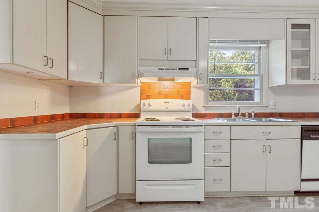 3806 Lee Road Raleigh, NC 27604 - Photo 10 of 33 a kitchen with granite countertop white cabinets and white appliances