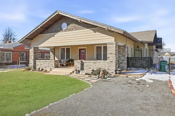 a front view of a house with a garden and patio