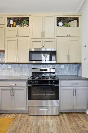 a stove top oven sitting inside of a kitchen