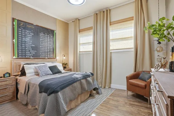 a bedroom with a bed a mirror and a table