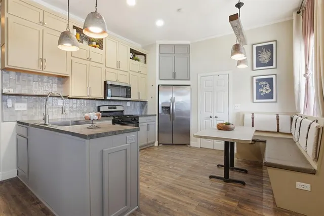 a kitchen with granite countertop a sink appliances and cabinets
