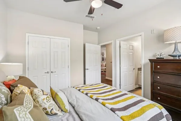 a bedroom with a bed and a chandelier