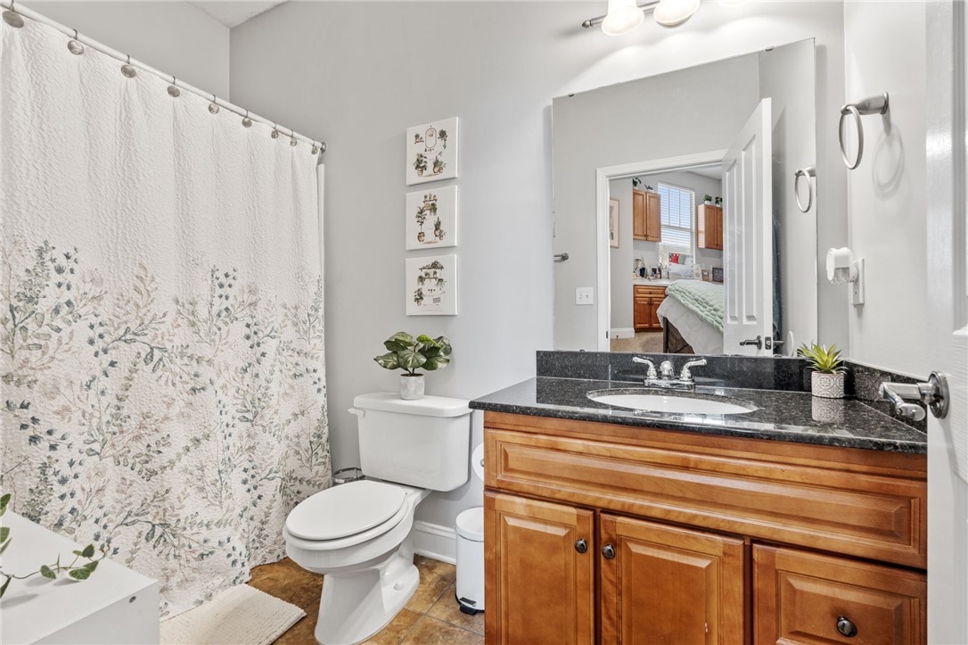 1432 Gadwall Way Seneca, SC 29678 - Photo 19 of 35 This bathroom features a sleek vanity, convenient toilet, and a tiled shower, offering a refreshing retreat.