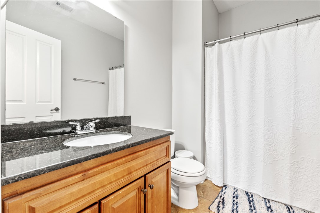 1432 Gadwall Way Seneca, SC 29678 - Photo 20 of 35 This bathroom features a sleek vanity with granite counters, offering a functional and clean space.