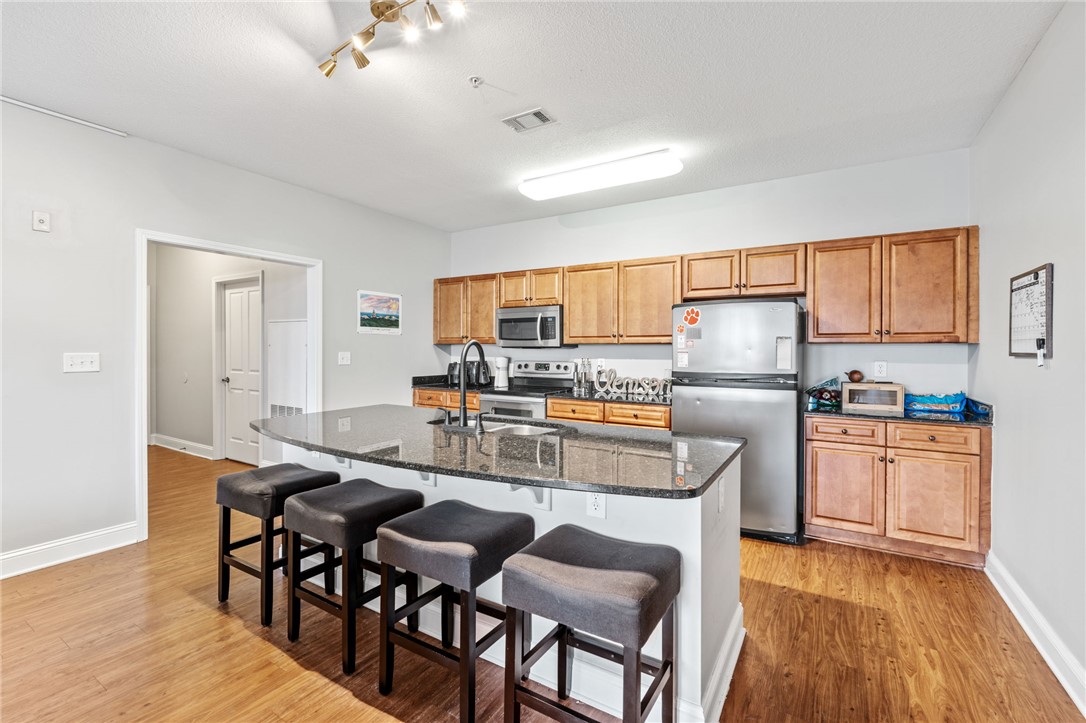 1432 Gadwall Way Seneca, SC 29678 - Photo 22 of 35 This modern kitchen features a spacious island with granite counters, perfect for casual dining and entertaining.