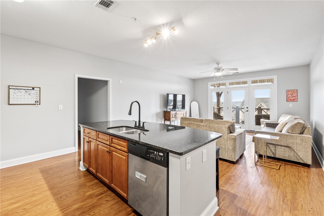 1432 Gadwall Way Seneca, SC 29678 - Photo 25 of 35 This living area features rich hardwood floors and an inviting kitchen island, perfect for entertaining.