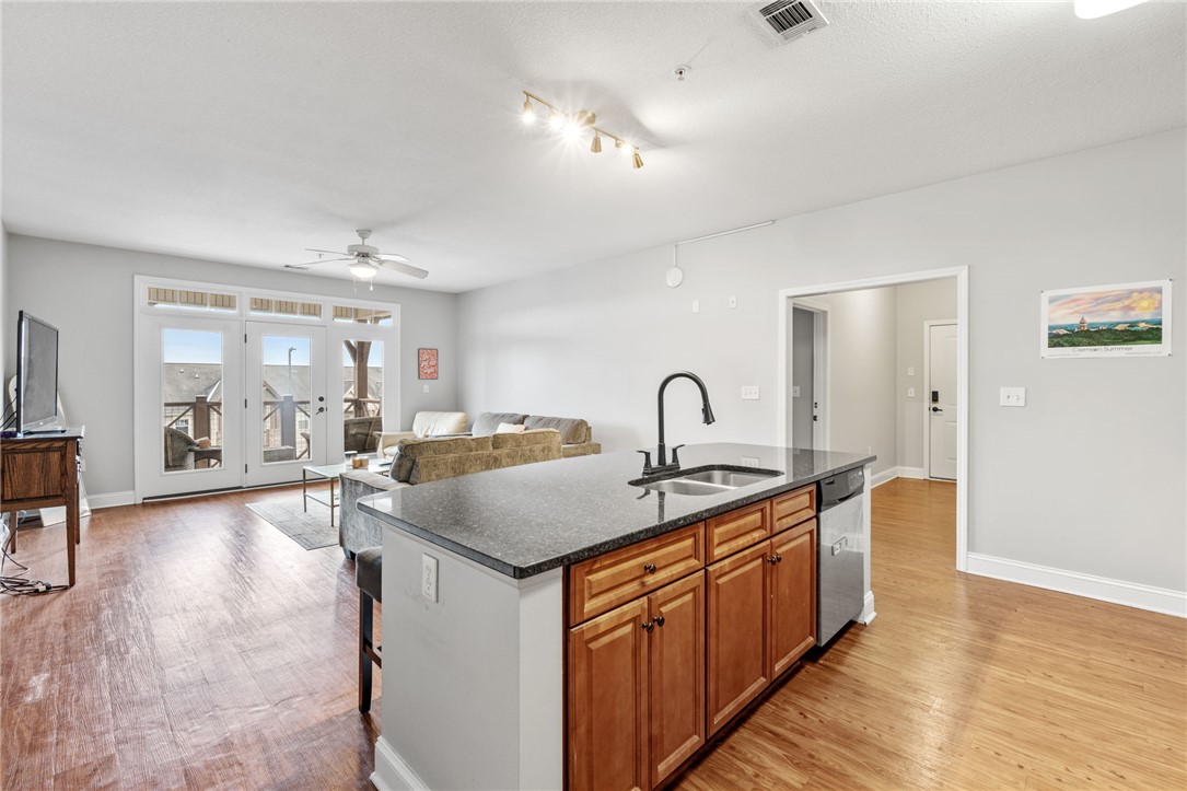 1432 Gadwall Way Seneca, SC 29678 - Photo 26 of 35 This open-concept space features a well-appointed kitchen island, seamlessly connecting to a bright living area with balcony access.