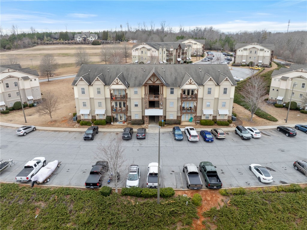 1432 Gadwall Way Seneca, SC 29678 - Photo 7 of 35 An aerial view showcases a multi-story apartment building with balconies and a spacious parking lot.