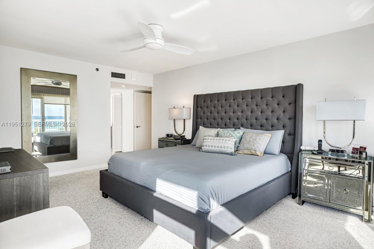 9341 Collins Avenue, Unit 201 Surfside, FL 33154 - Photo 12 of 34 a bedroom with a bed and a couch