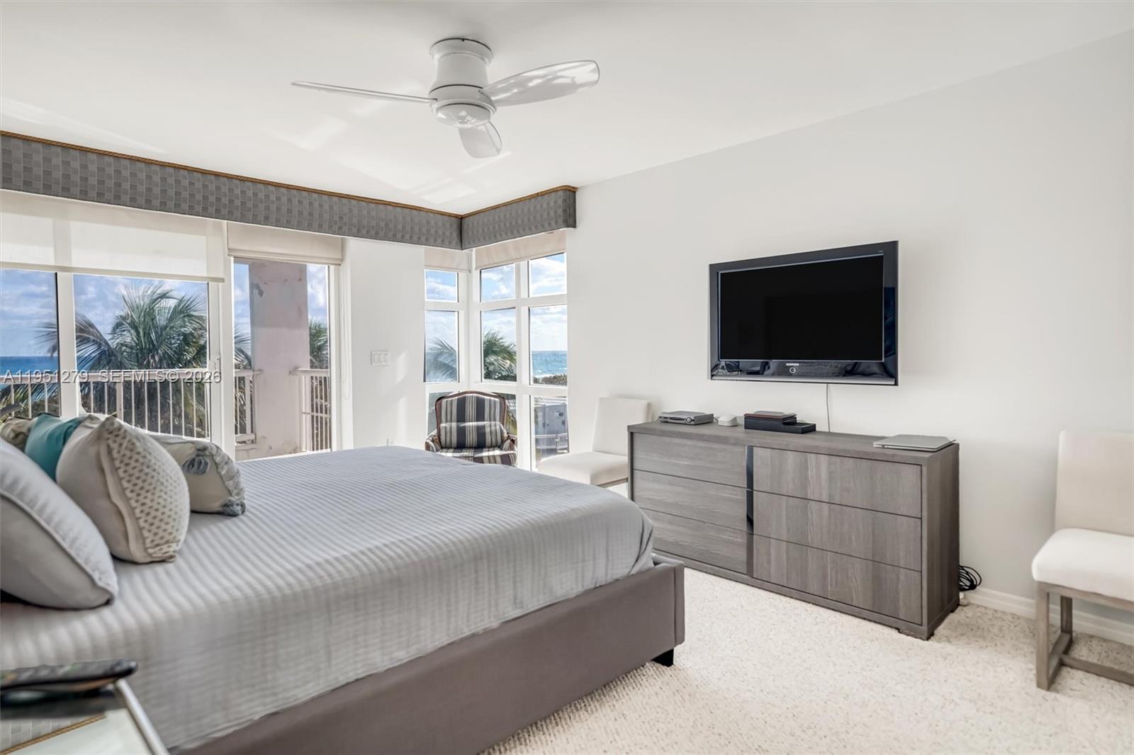 9341 Collins Avenue, Unit 201 Surfside, FL 33154 - Photo 14 of 34 a bedroom with a bed and a flat screen tv