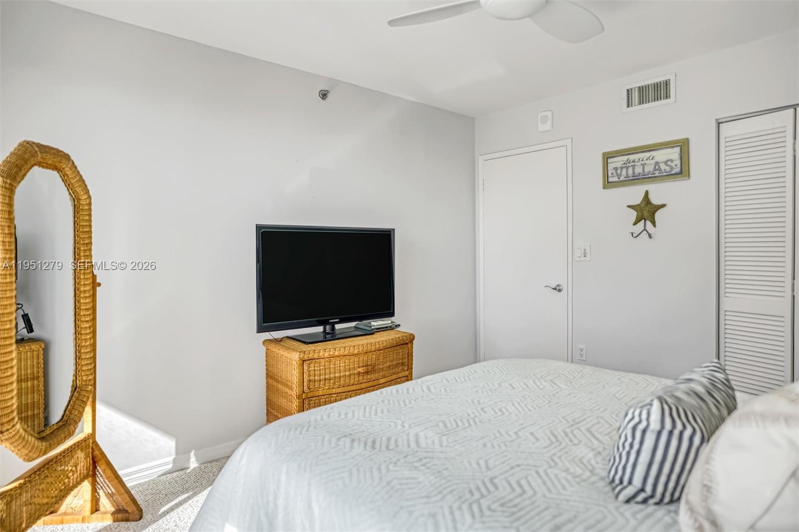 9341 Collins Avenue, Unit 201 Surfside, FL 33154 - Photo 19 of 34 a bedroom with a bed and a flat screen tv