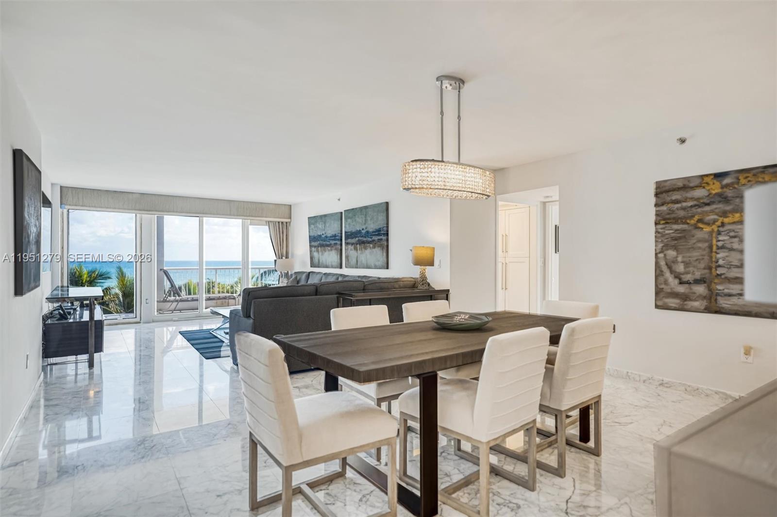 9341 Collins Avenue, Unit 201 Surfside, FL 33154 - Photo 6 of 34 a view of a dining room with furniture window and outside view