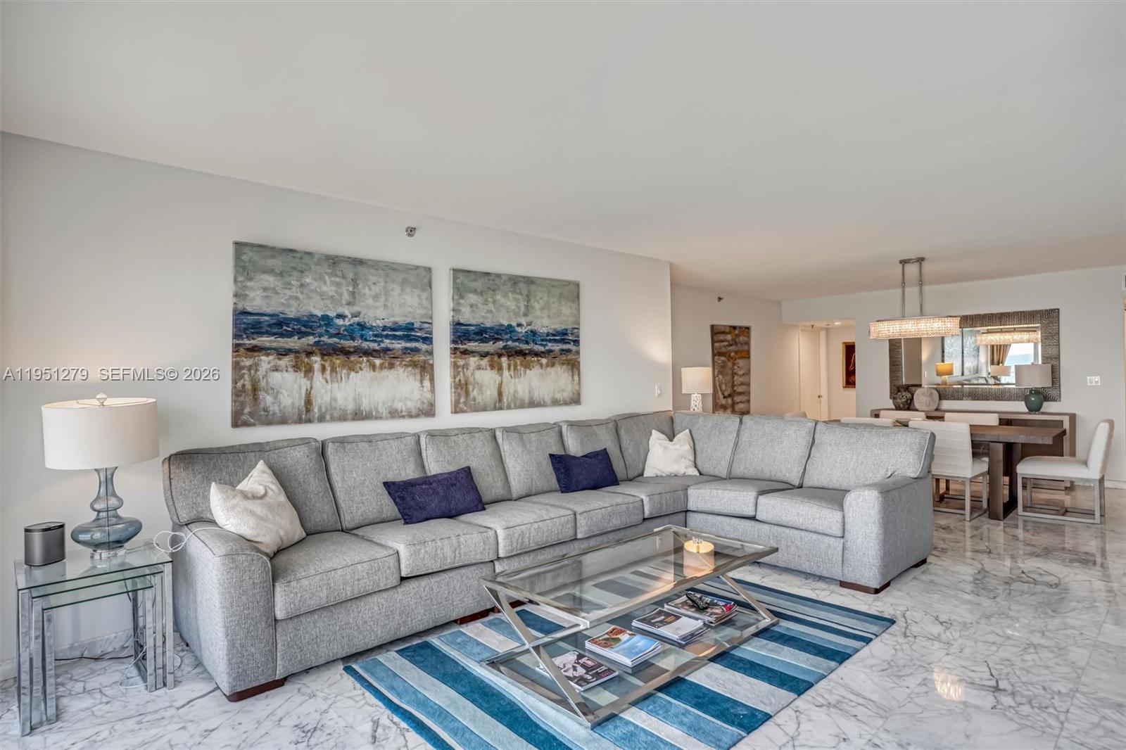 9341 Collins Avenue, Unit 201 Surfside, FL 33154 - Photo 9 of 34 a living room with furniture and a couch