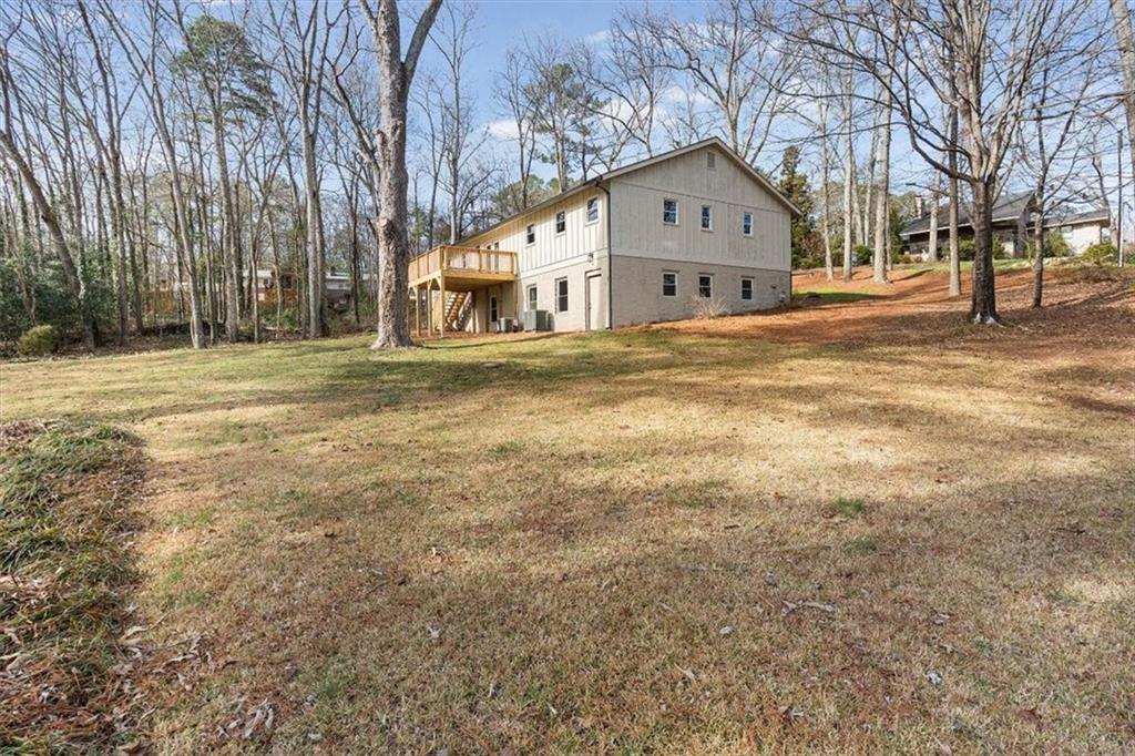 49 Apache Trail Cartersville, GA 30120 - Photo 47 of 52 a front view of a building with large trees