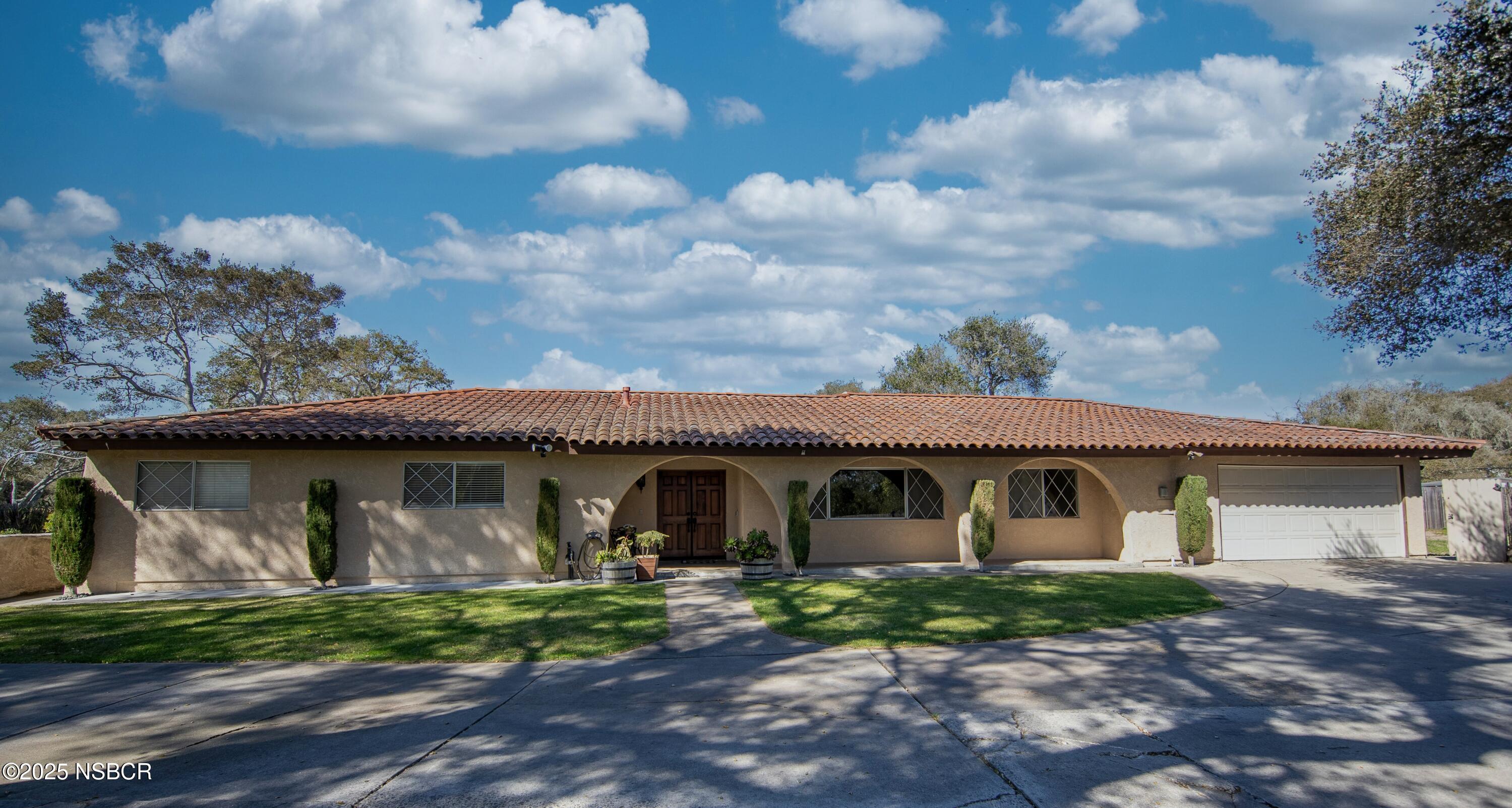a front view of a house with garden