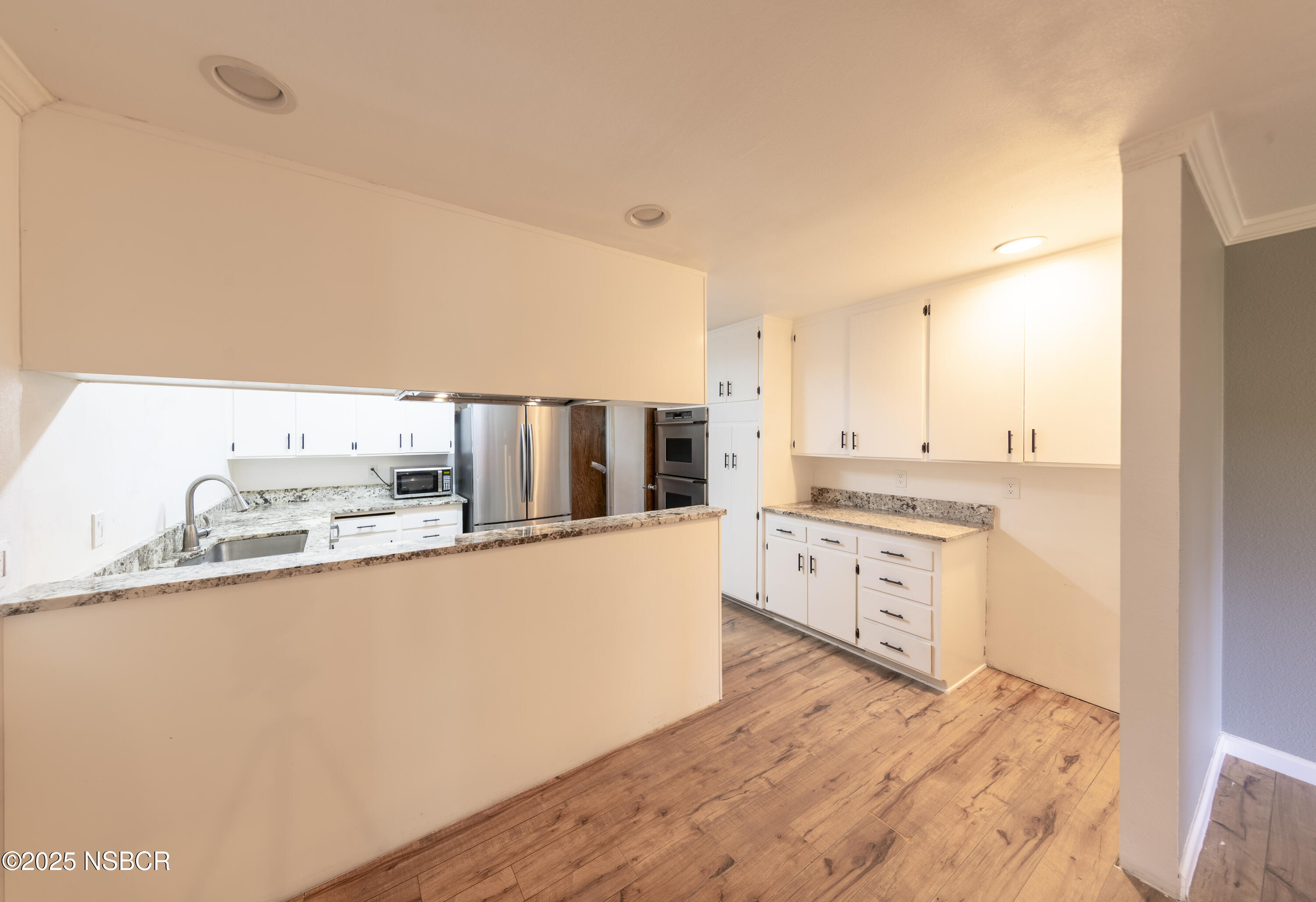 3118 Pellham Drive Lompoc, CA 93436 - Photo 26 of 56 a large white kitchen with kitchen island a sink a stove and refrigerator