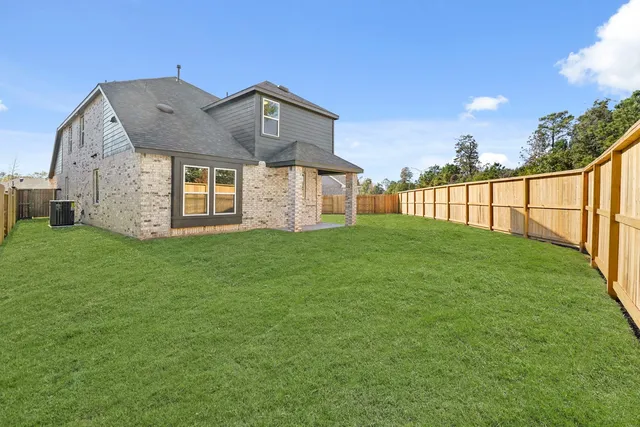 a view of a backyard with a garden and trees