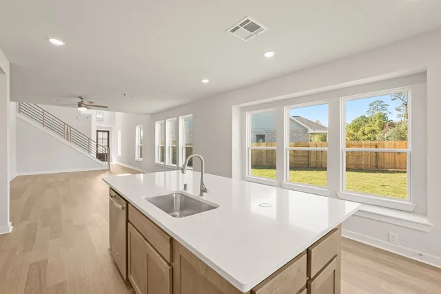 a kitchen with kitchen island a sink and a large window