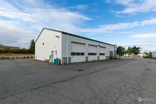 a view of a house with a big yard and large trees