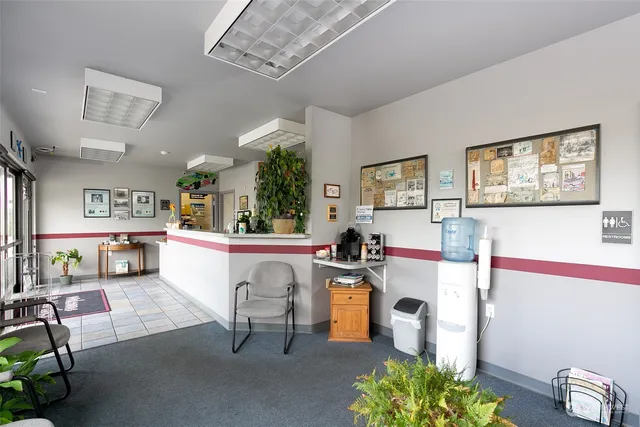 a living room with furniture and a kitchen