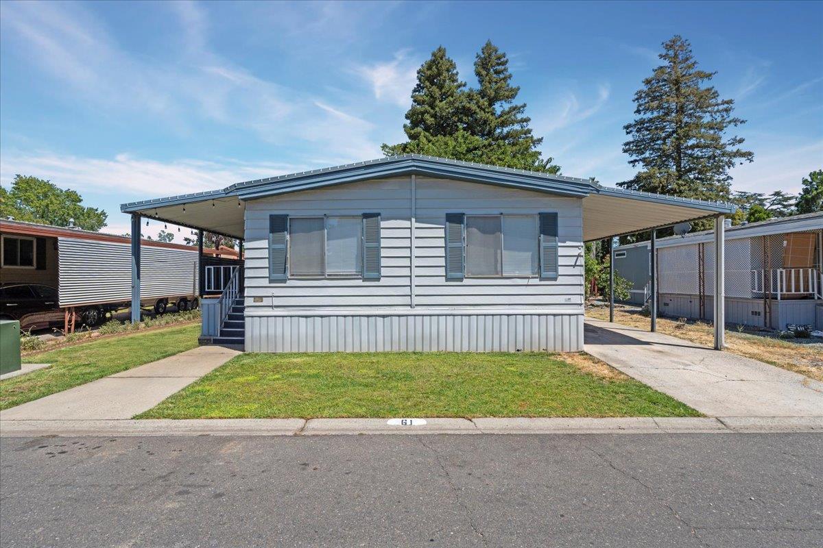 61 Maple Drive Sacramento, CA 95823 - Photo 1 of 1 a view of a house with a small yard and a large parking space