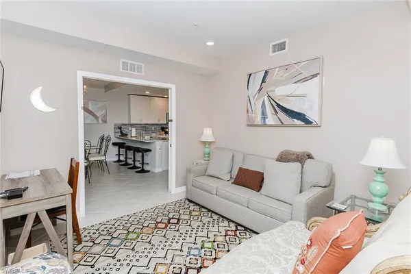 a living room with furniture and a rug