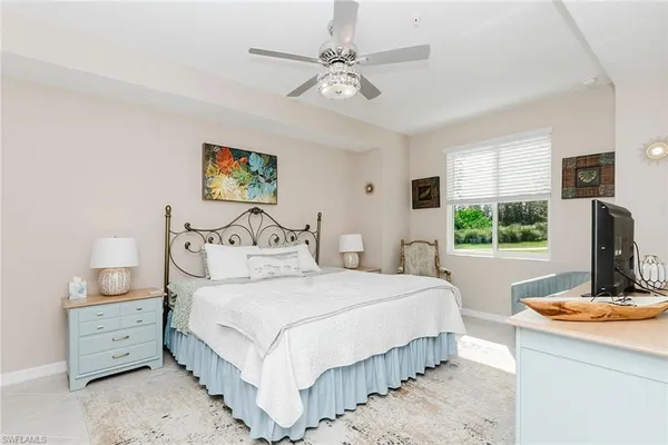 a bedroom with a bed and a table with a large mirror