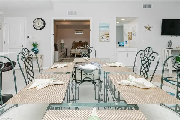 a living room with furniture a flat screen tv and a table