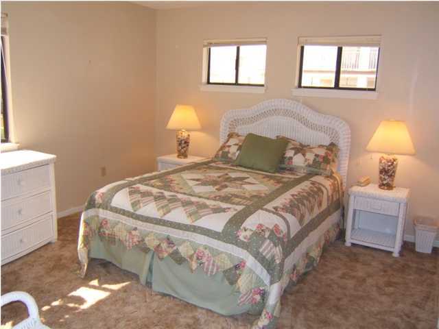 665 Eastern Lake Road Santa Rosa Beach, FL 32459 - Photo 8 of 11 a bedroom with a bed and a lamp