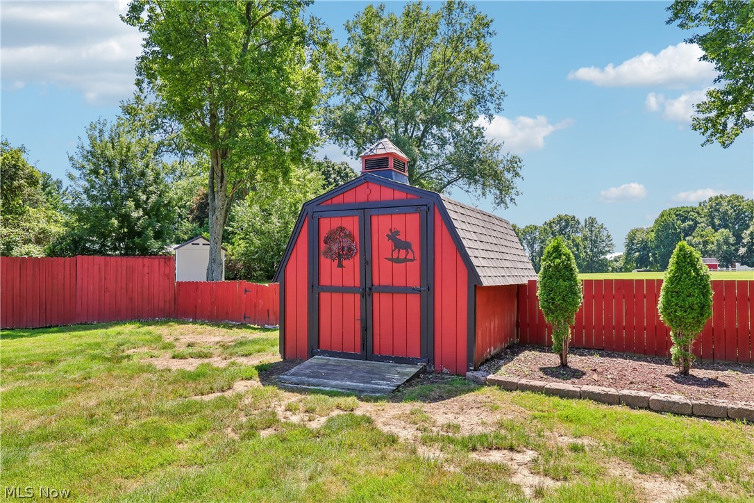 6109 North Oval Road Clinton, OH 44216 - Photo 44 of 47 Red barn-style shed featuring double doors and a cupola