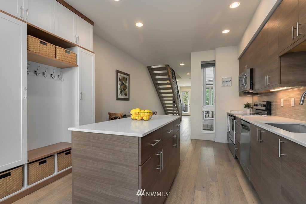 1730 Northwest 60th Street Seattle, WA 98107 - Photo 11 of 25 a kitchen with stainless steel appliances granite countertop a sink a stove and a refrigerator