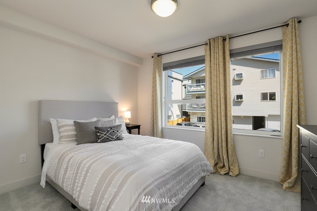 1730 Northwest 60th Street Seattle, WA 98107 - Photo 12 of 25 a bedroom with a large bed and a window