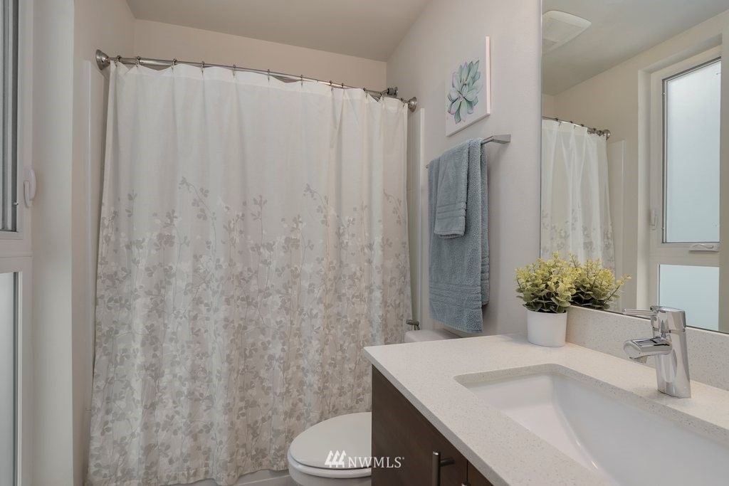 1730 Northwest 60th Street Seattle, WA 98107 - Photo 13 of 25 a bathroom with a sink toilet and shower