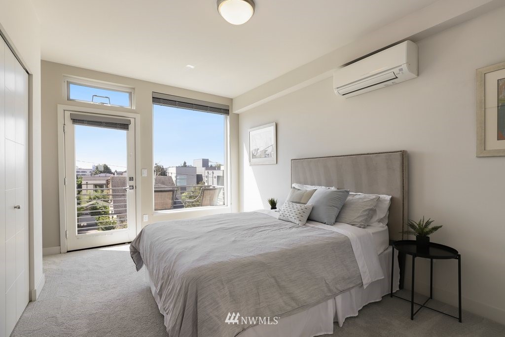 1730 Northwest 60th Street Seattle, WA 98107 - Photo 16 of 25 a bedroom with a large bed and a large window