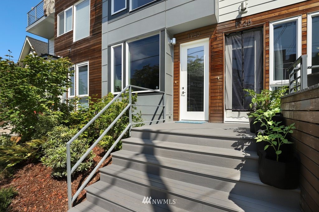 1730 Northwest 60th Street Seattle, WA 98107 - Photo 24 of 25 a view of a house with a potted plant and floor to ceiling windows