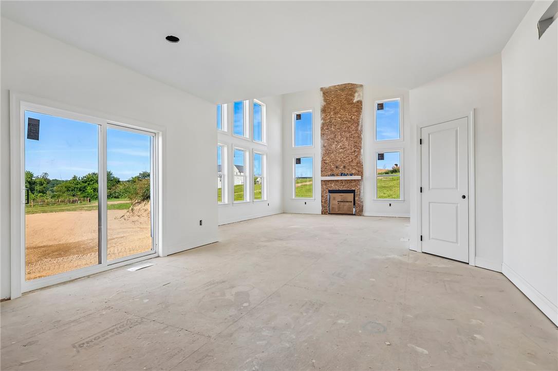 3237 Michaels School Road, Unit 9 Nazareth, PA 18064 - Photo 13 of 56 Towering windows frame rolling green views from this airy, fireplace-centered living area.