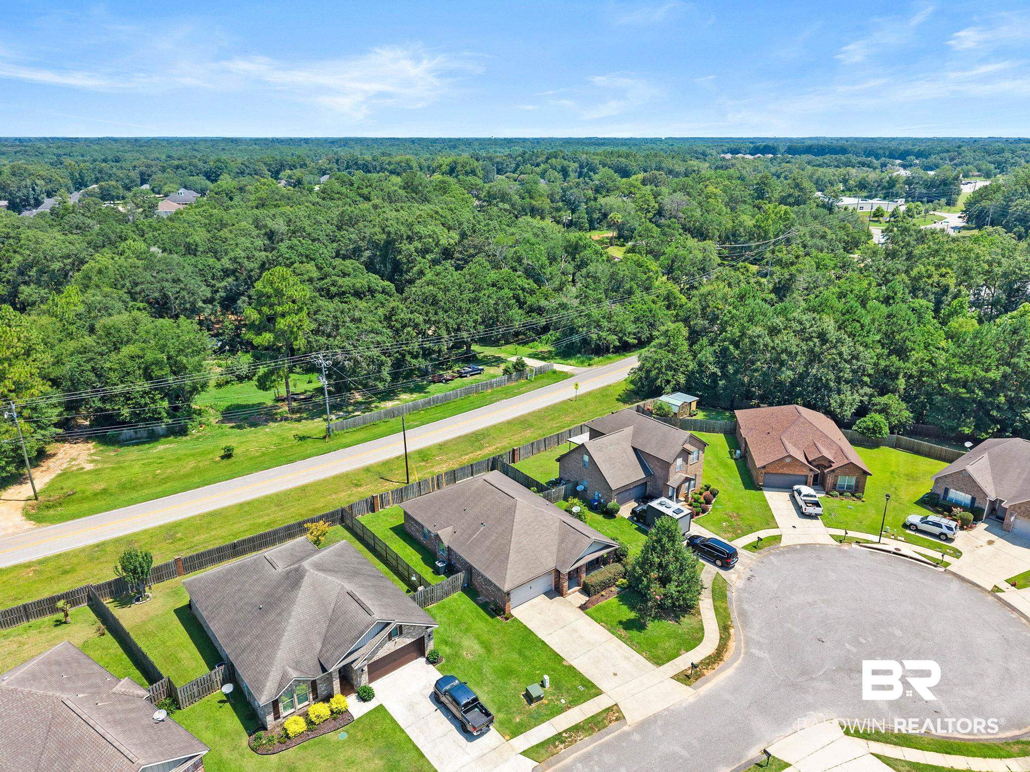 2216 Livingstone Court Mobile, AL 36695 - Photo 57 of 62 Aerial perspective showcasing a residential cul-de-sac with manicured lawns, paved driveways, and mature trees bordering the properties