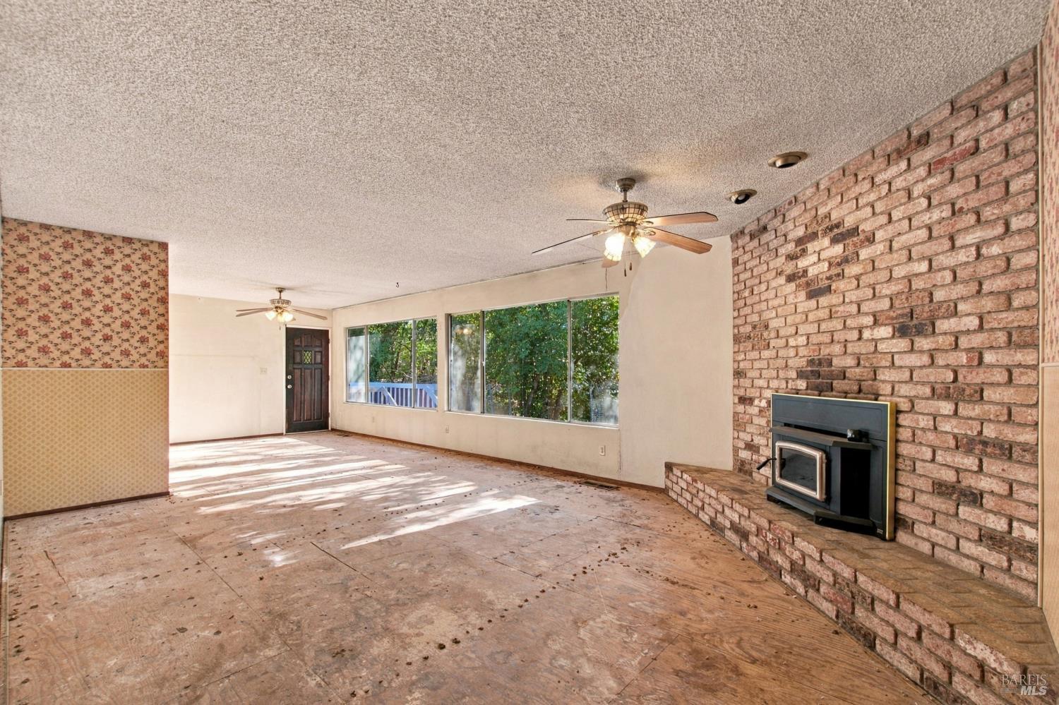 1075 Partrick Road Napa, CA 94558 - Photo 6 of 57 Living room view to dining area and picture windows to creek side setting