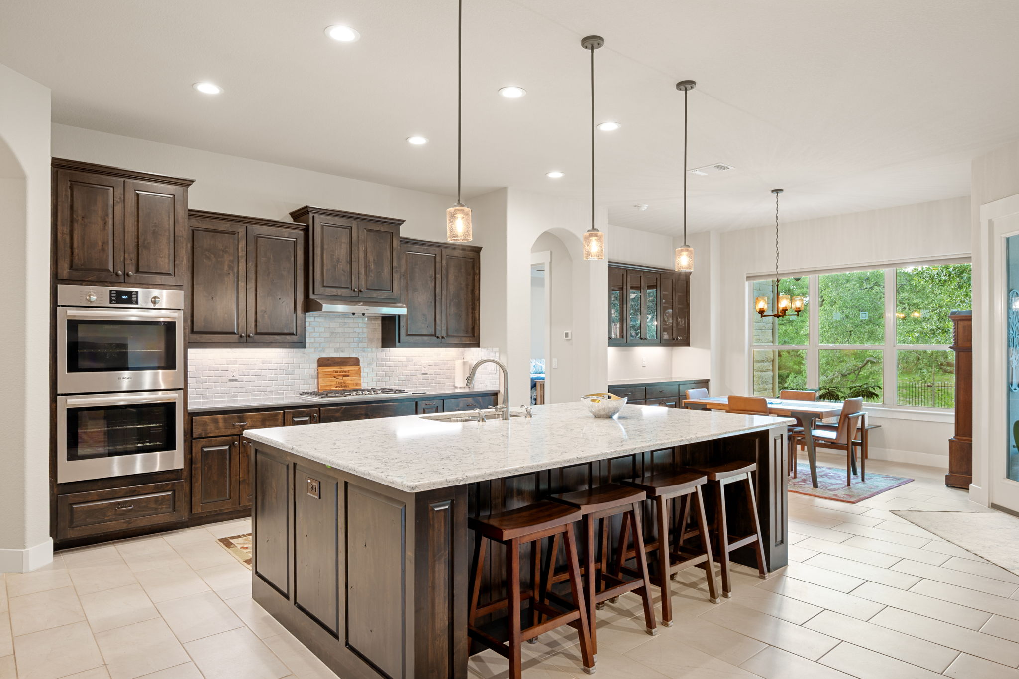 212 Marbella Way Georgetown, TX 78633 - Photo 11 of 40 a kitchen with stainless steel appliances granite countertop a stove top oven a refrigerator and a center island